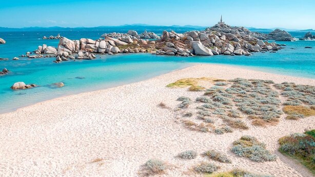 A beach with clear turquoise water, large rocks, and a sandy shore. - Les Pavillons du Golfe (Conca)