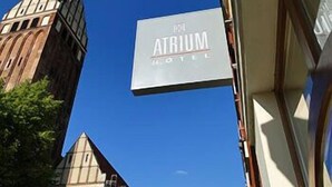 A hotel sign with the name 'Atrium Hotel'.