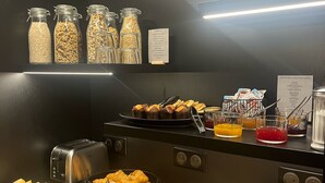 A breakfast buffet with various food items and condiments.
