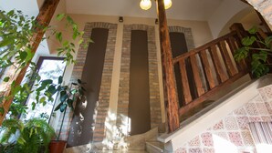A staircase with wooden railings and brick walls. - Révész Hotel (Gyor)