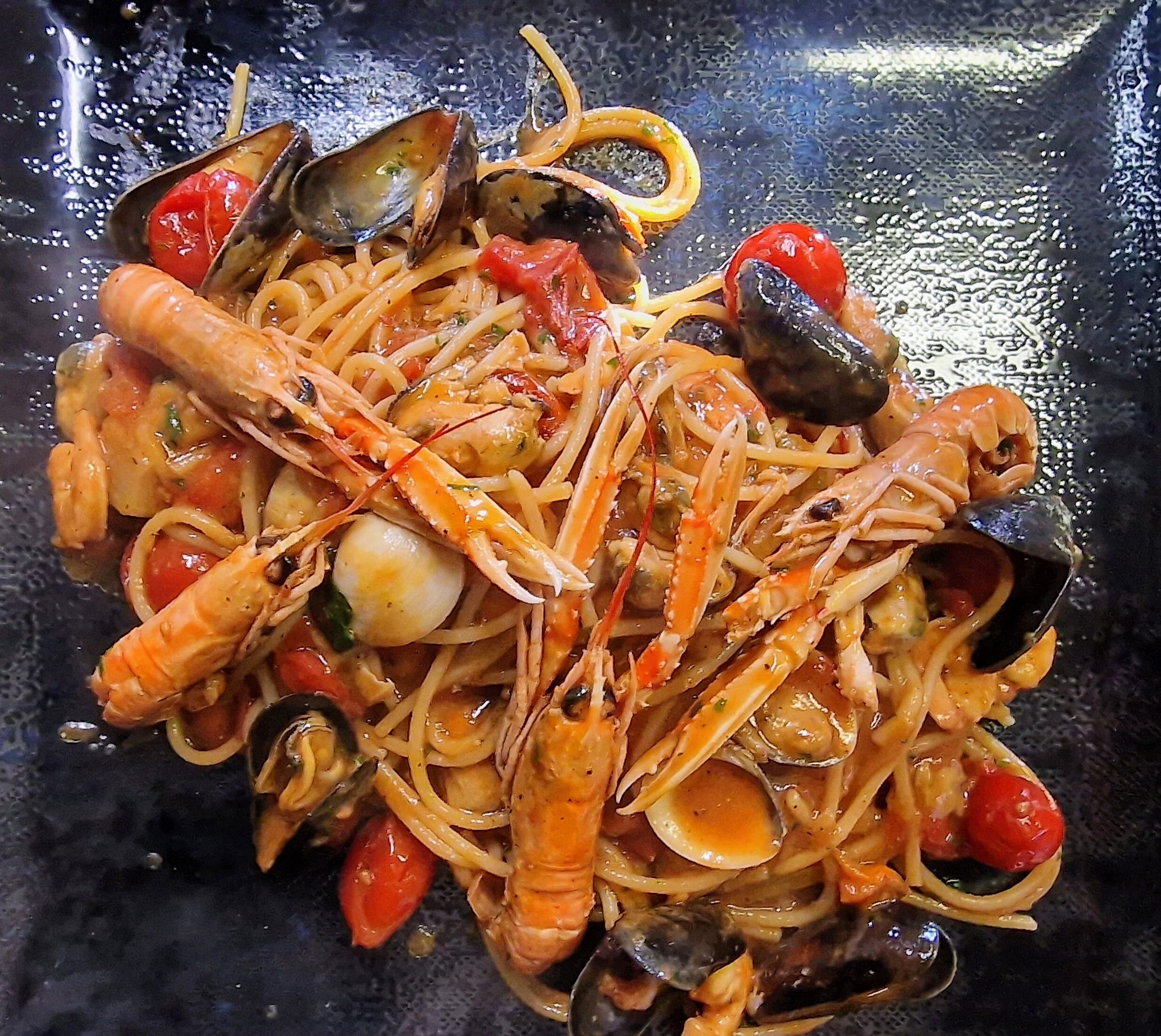 A seafood pasta dish with shrimp, mussels, and clams.