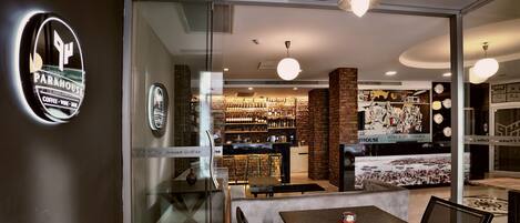 A modern interior with a dining area, a coffee bar, and a visible kitchen.