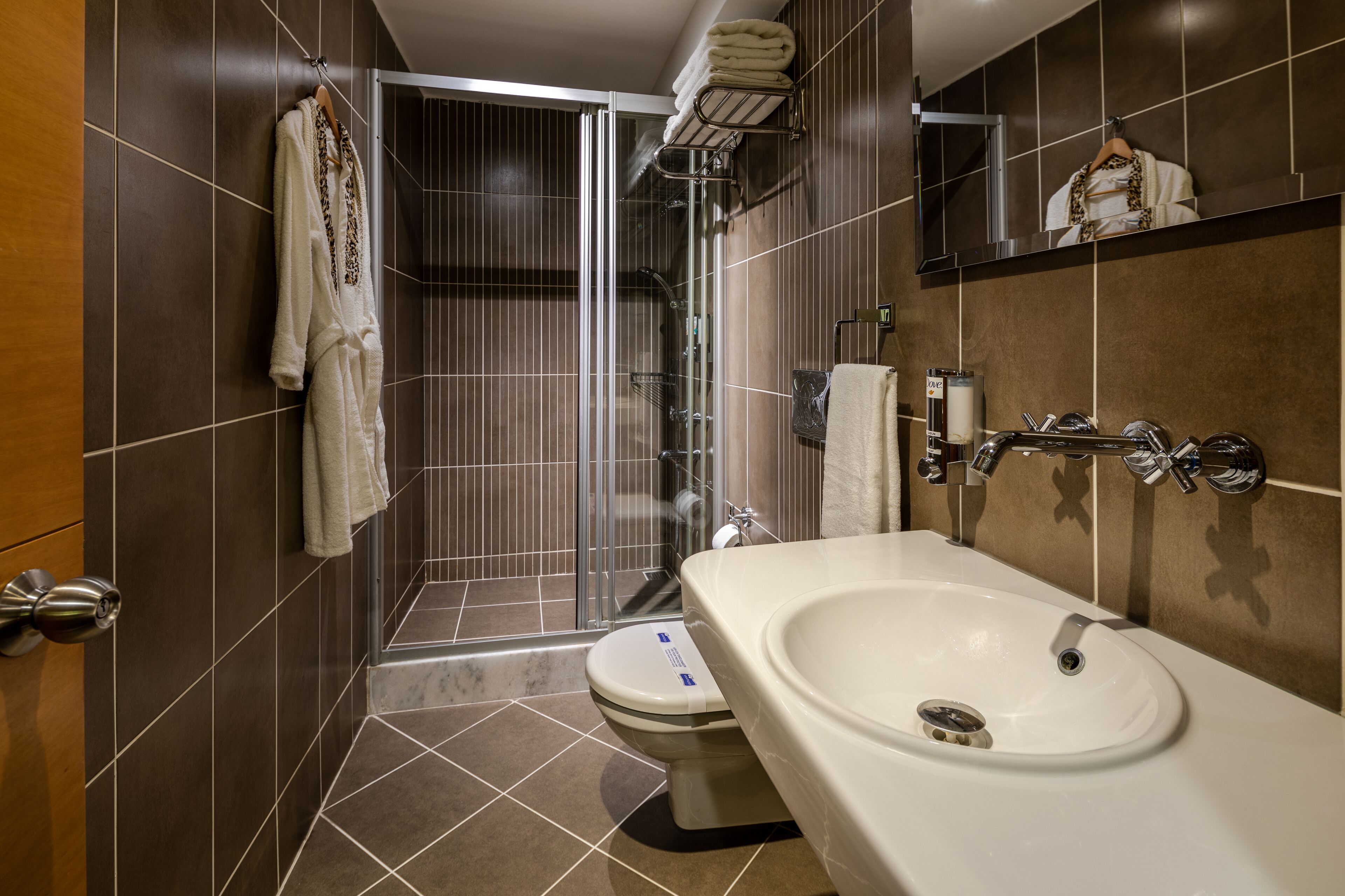 deluxe room | bathroom | jetted bath, rainfall showerhead, designer toiletries, hair dryer