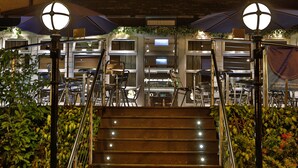 A staircase leading to a bar/lounge area with metal railings and overhead lighting. - Best Western Motherwell Centre Moorings Hotel (Motherwell)