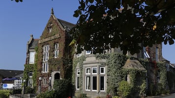 Experience the charm of a traditional building with a classic architectural style, featuring a prominent corner entrance and a large bay window.