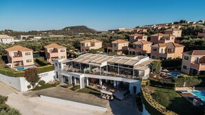A modern resort with a rooftop bar, swimming pool, and hillside views. - St. John Villas Zakynthos (Zakynthos)