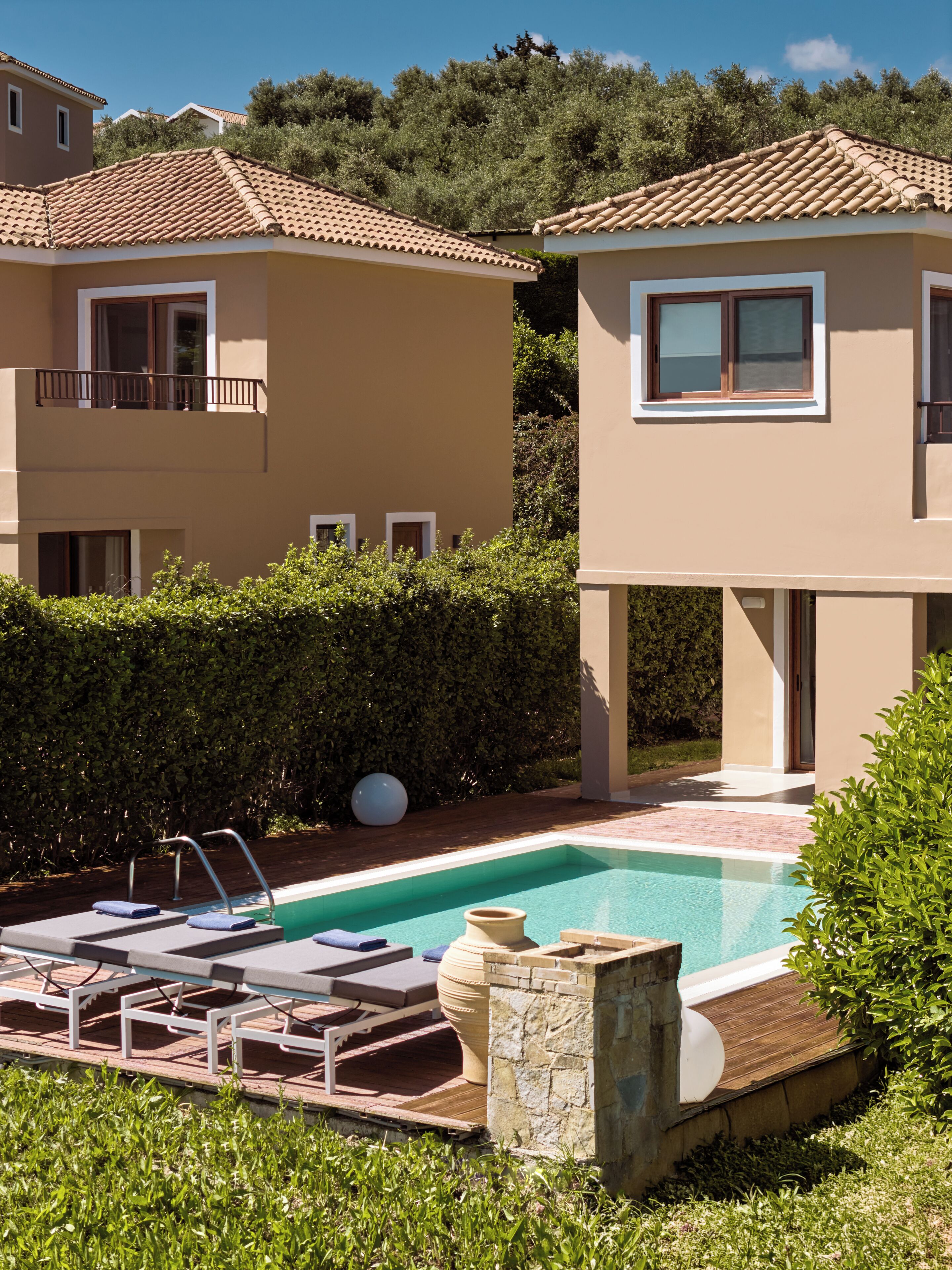 A residential property with a swimming pool, two-story buildings, and a well-maintained garden.