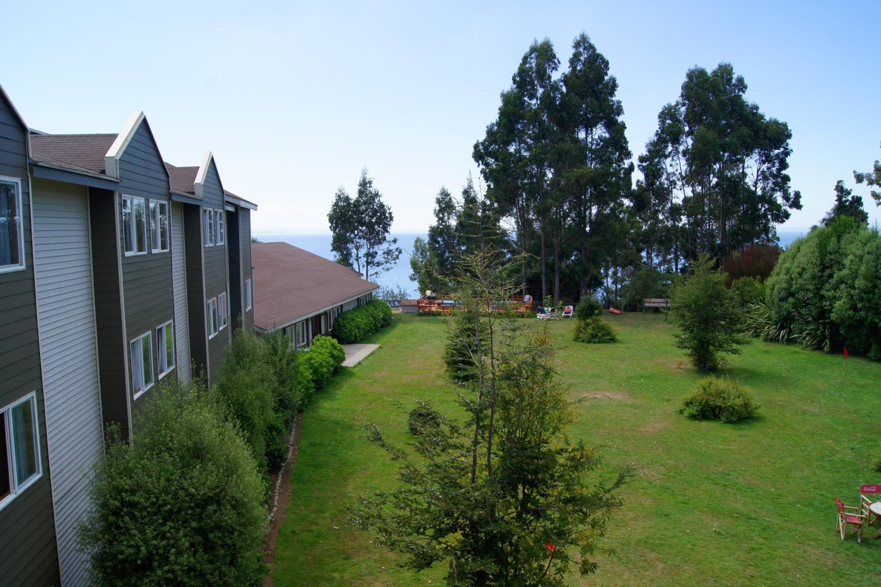A residential building with multiple windows and a well-maintained lawn.