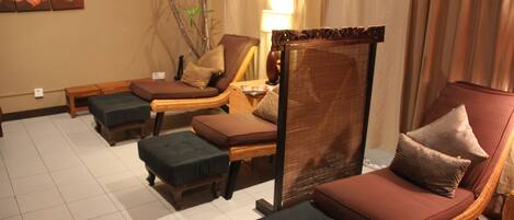 A room with a sofa, a chair, and a small table.