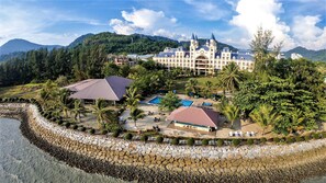 A resort with a large building, a swimming pool, and a beach area. - Bella Vista Waterfront Resort (Langkawi)
