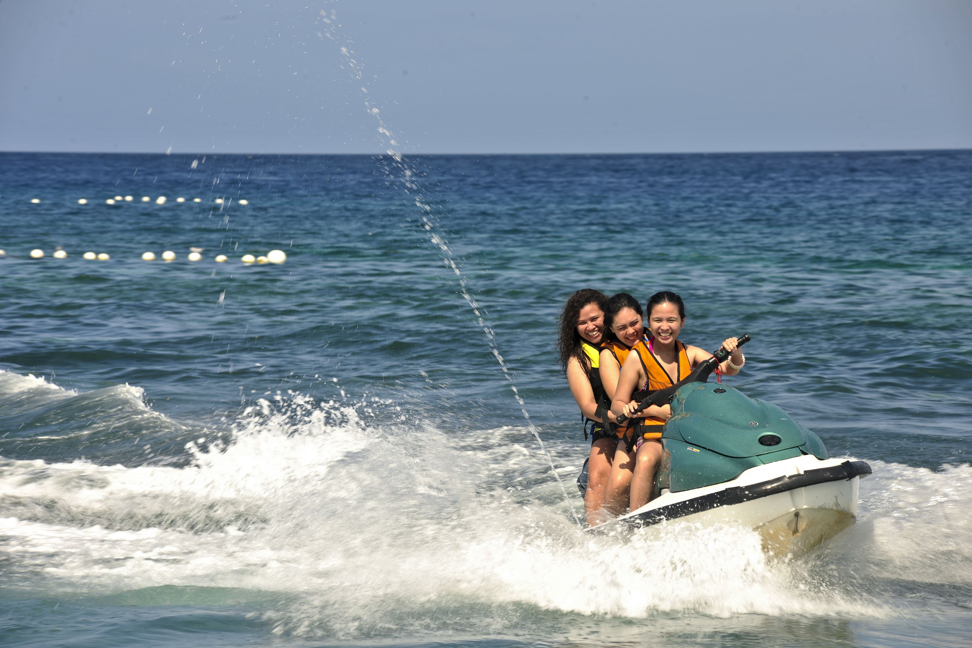 Two people on a jet ski in the ocean.