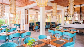 A restaurant with outdoor seating, wooden ceiling, and hanging light fixtures. - Costabella Tropical Beach Hotel (Lapu-Lapu)