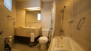 A bathroom with a toilet, sink, bathtub, and shower. - Royal Bellagio Hotel (Makati)