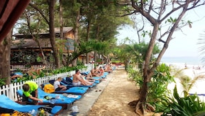 A beachside lounge with sunbeds and a sandy path leading to the beach. - Vinh Suong Seaside (Mui Ne)