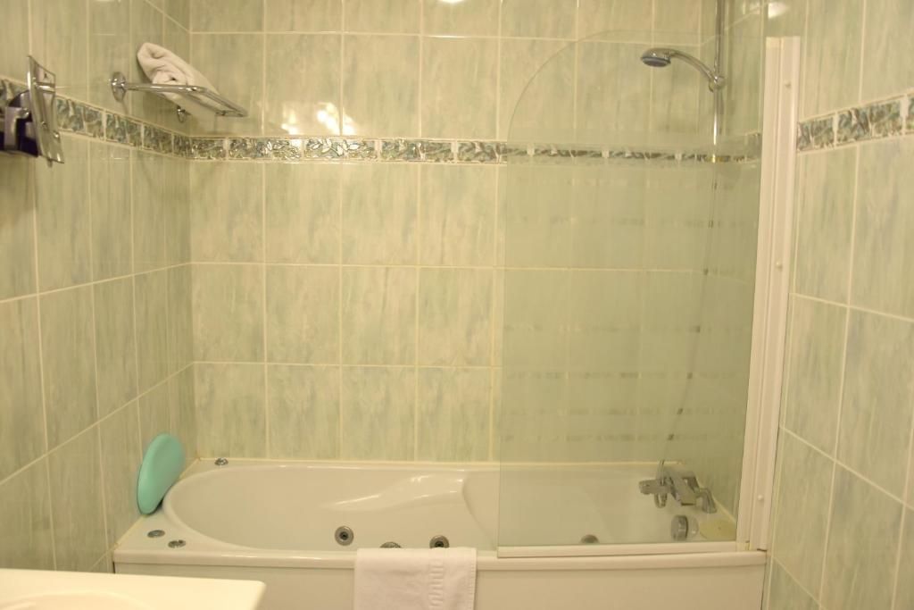 A bathroom with a bathtub, a shower, and a toilet.
