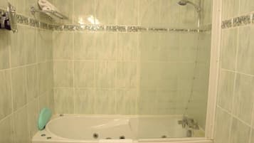A bathroom with a bathtub, a shower, and a toilet.