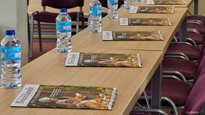 A conference room with a long table set up with water bottles and brochures for a hotel named 'Broceliande'. - Hotel Le Relais De Broceliande (Paimpont)
