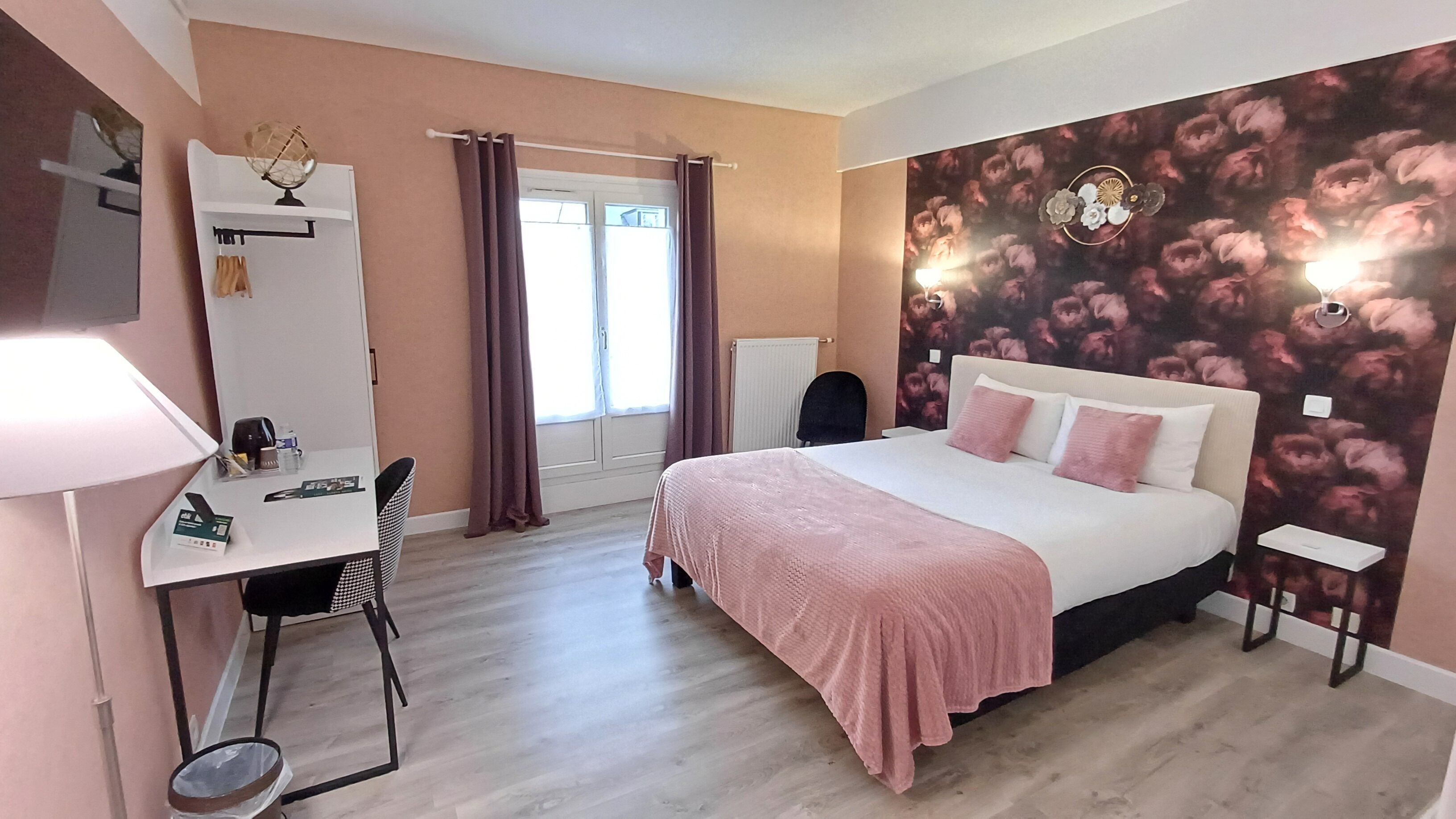 A bedroom with a bed, a desk, a chair, a radiator, and a window with curtains.