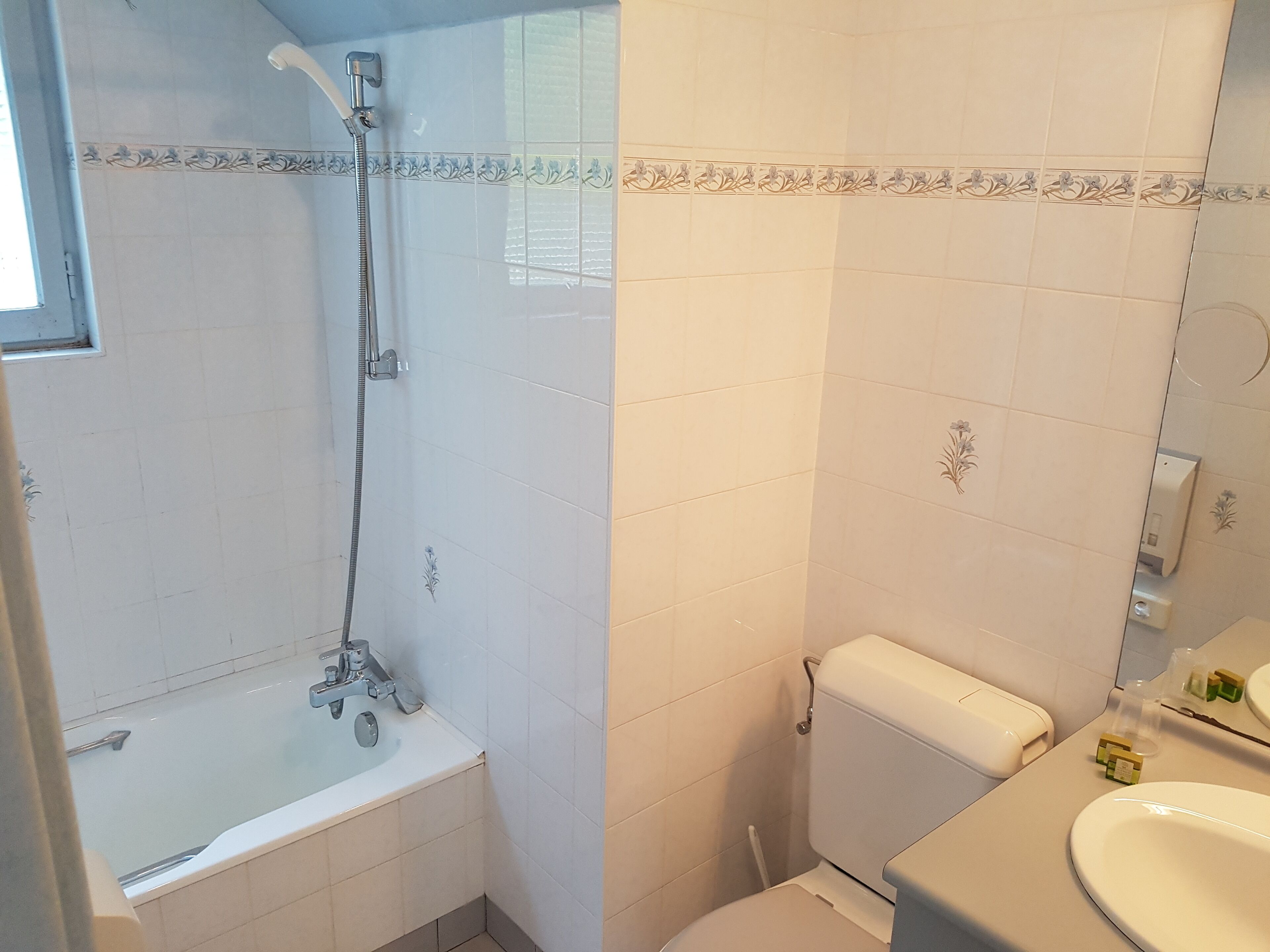 A bathroom with a bathtub, toilet, and sink.