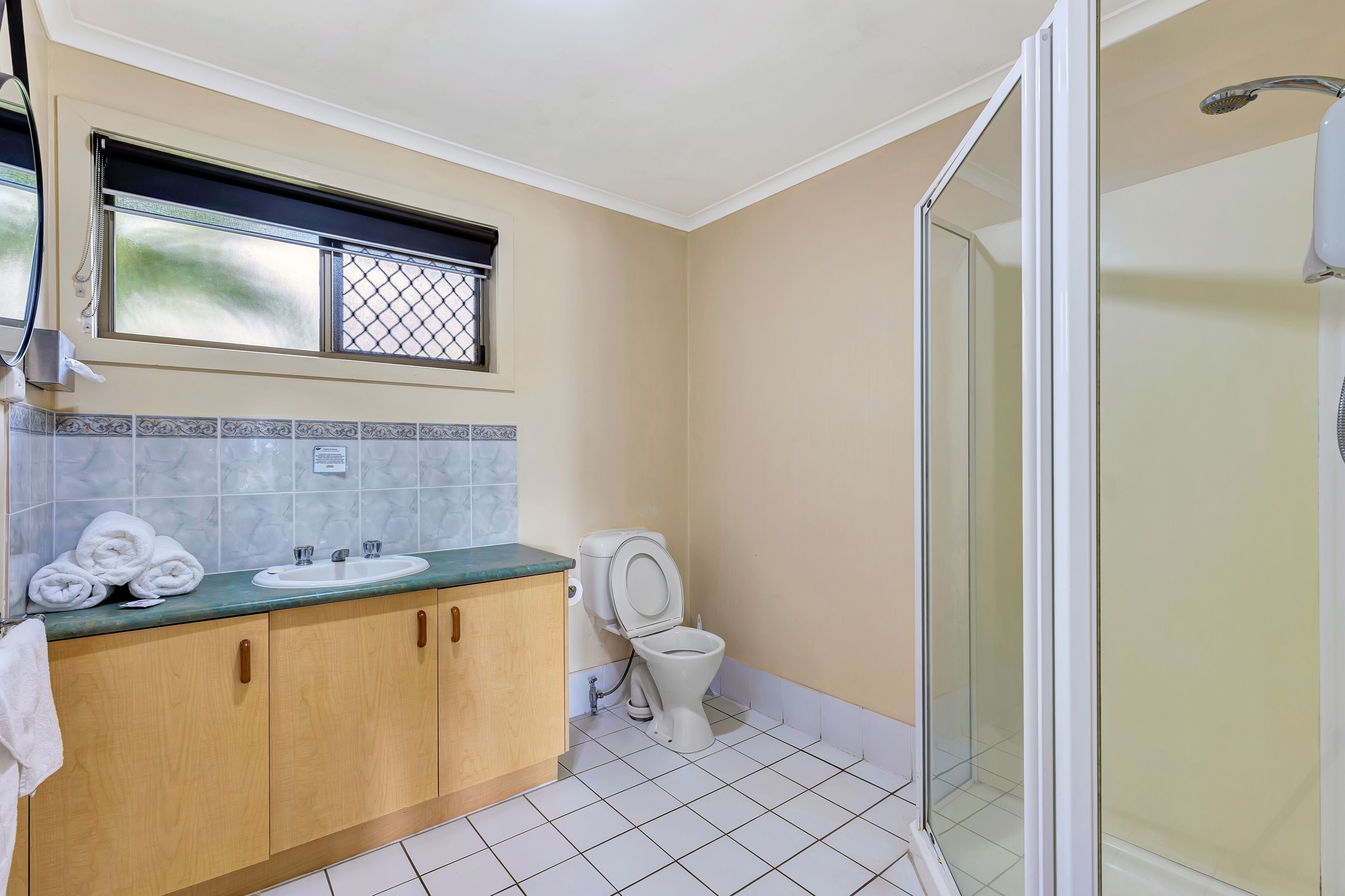 Une salle de bain comprenant des toilettes, un lavabo et une douche.