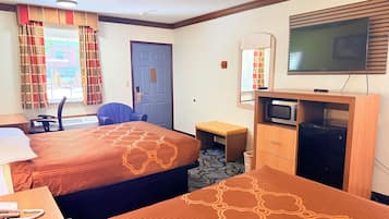 A hotel room with two beds, a desk, a chair, a television, and a microwave.
