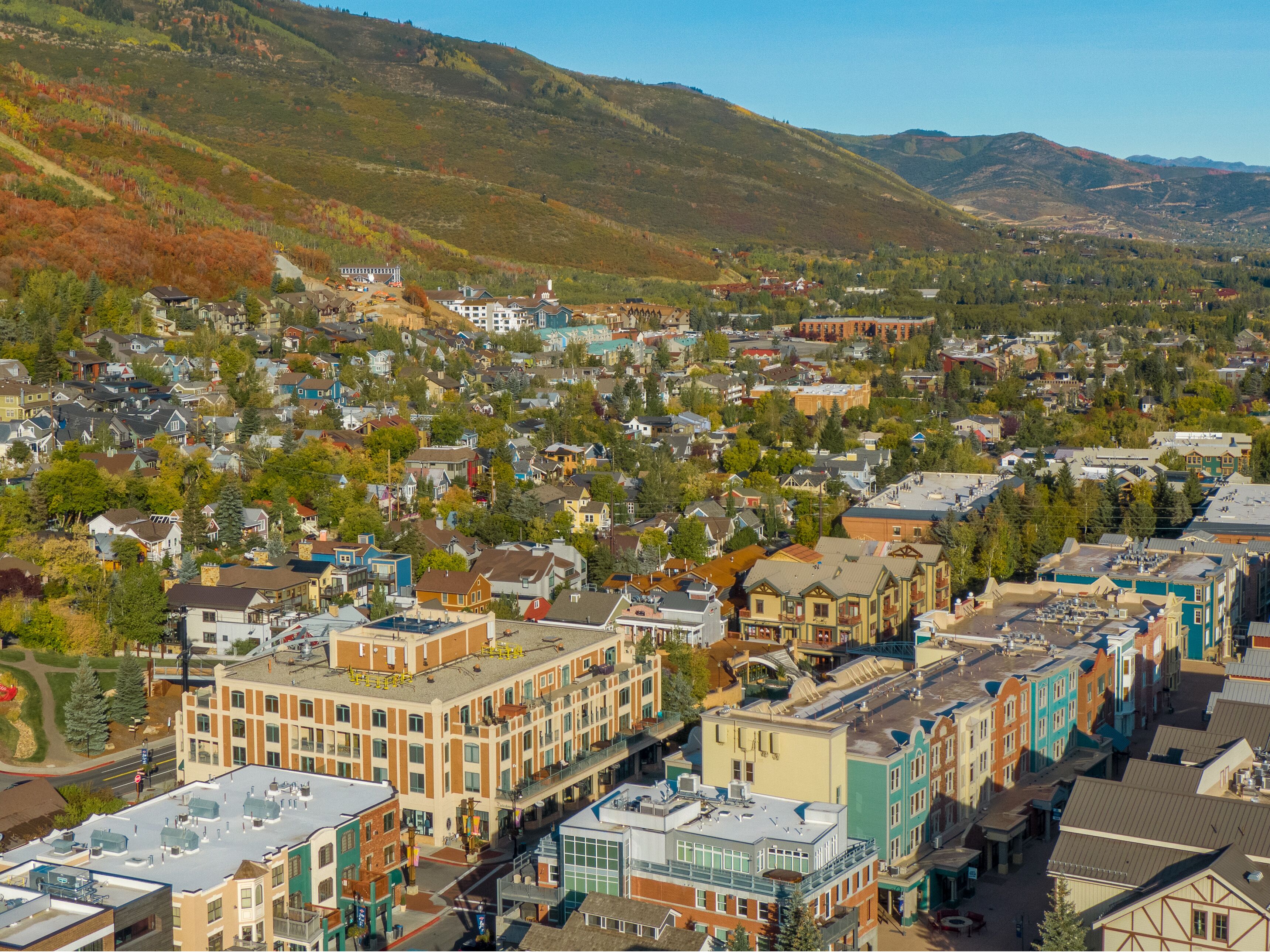 A town with a mix of residential and commercial buildings, including a prominent hotel with a large sign.