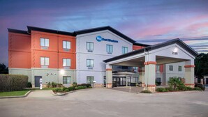 A Best Western hotel with a modern design, featuring a two-story structure, a covered entrance, and a parking area.