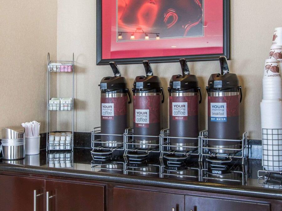 A coffee station with four dispensers labeled 'YOUR morning coffee' in different flavors.