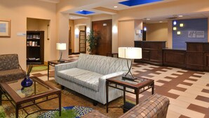 A lobby with a reception desk, a sofa, a coffee table, and a bookshelf. - Holiday Inn Express Columbia by IHG (Columbia)