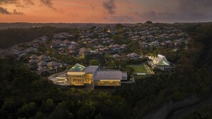A residential area with multiple houses, a modern building with glass facade, and a large estate with a distinctive roof. - Umana Bali, LXR Hotels & Resorts (Ungasan)
