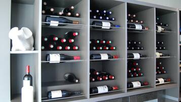 A wine rack with multiple shelves holding various bottles of wine.