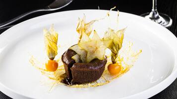 A dessert on a white plate with a dark background.