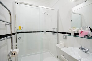 Shower, designer toiletries, hair dryer, towels