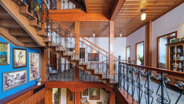 A wooden staircase with wrought iron railings leading to an upper level. - Hotel Bosnali - Special Class (Adana)