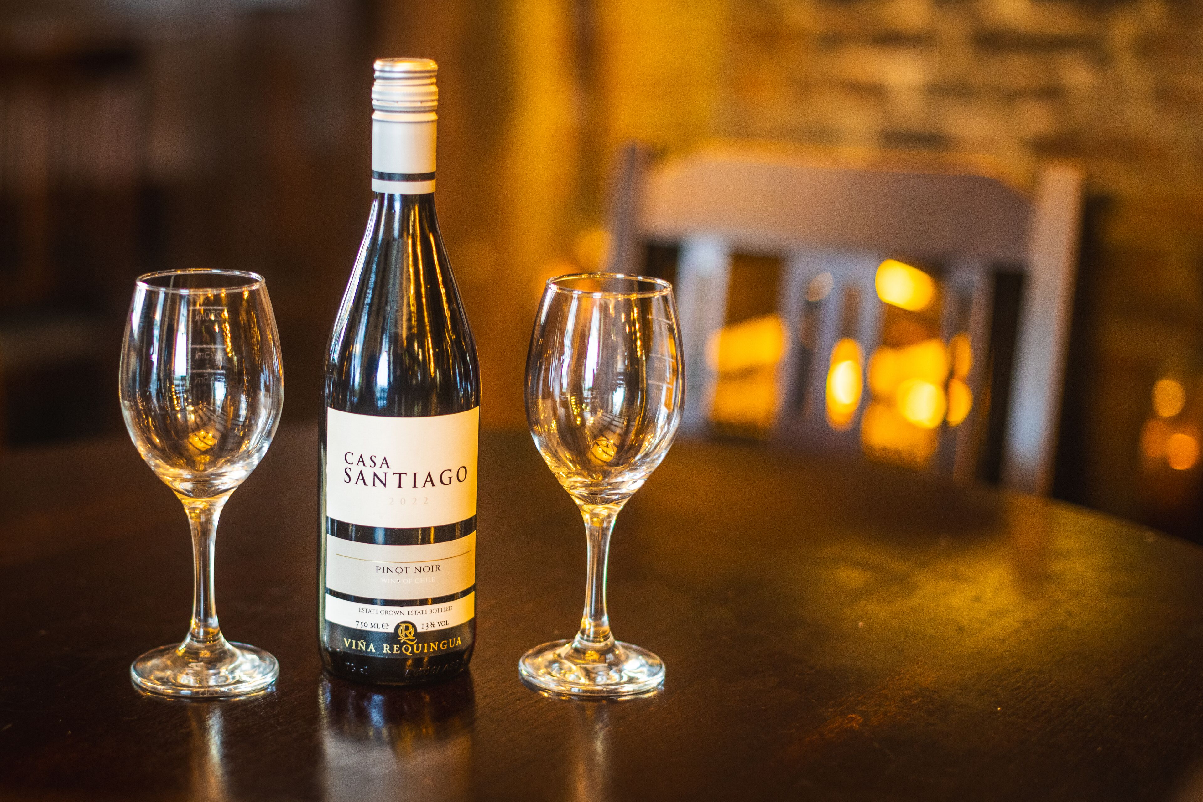 Une bouteille de vin et deux verres sur une table.