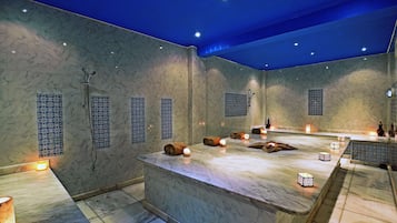 Relax in a serene spa area with a central water feature, comfortable seating, and a soothing ambiance.