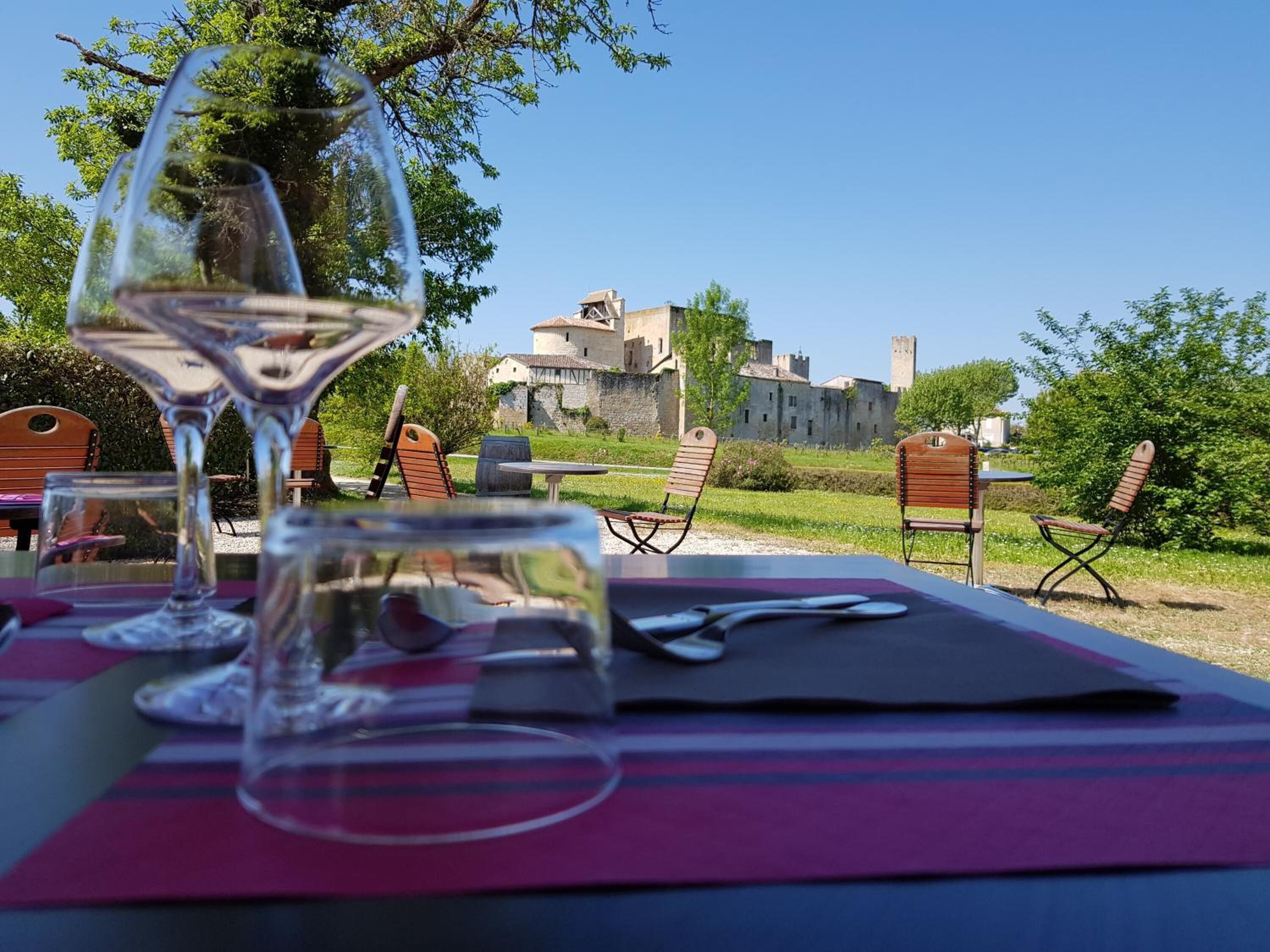A table set outdoors with a view of a historic building in the background.