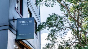 A building with a sign that reads "PEROUSE RANDBWICK" and a website address "www.staylocal.sydney". - Perouse Randwick by Sydney Lodges (Randwick)