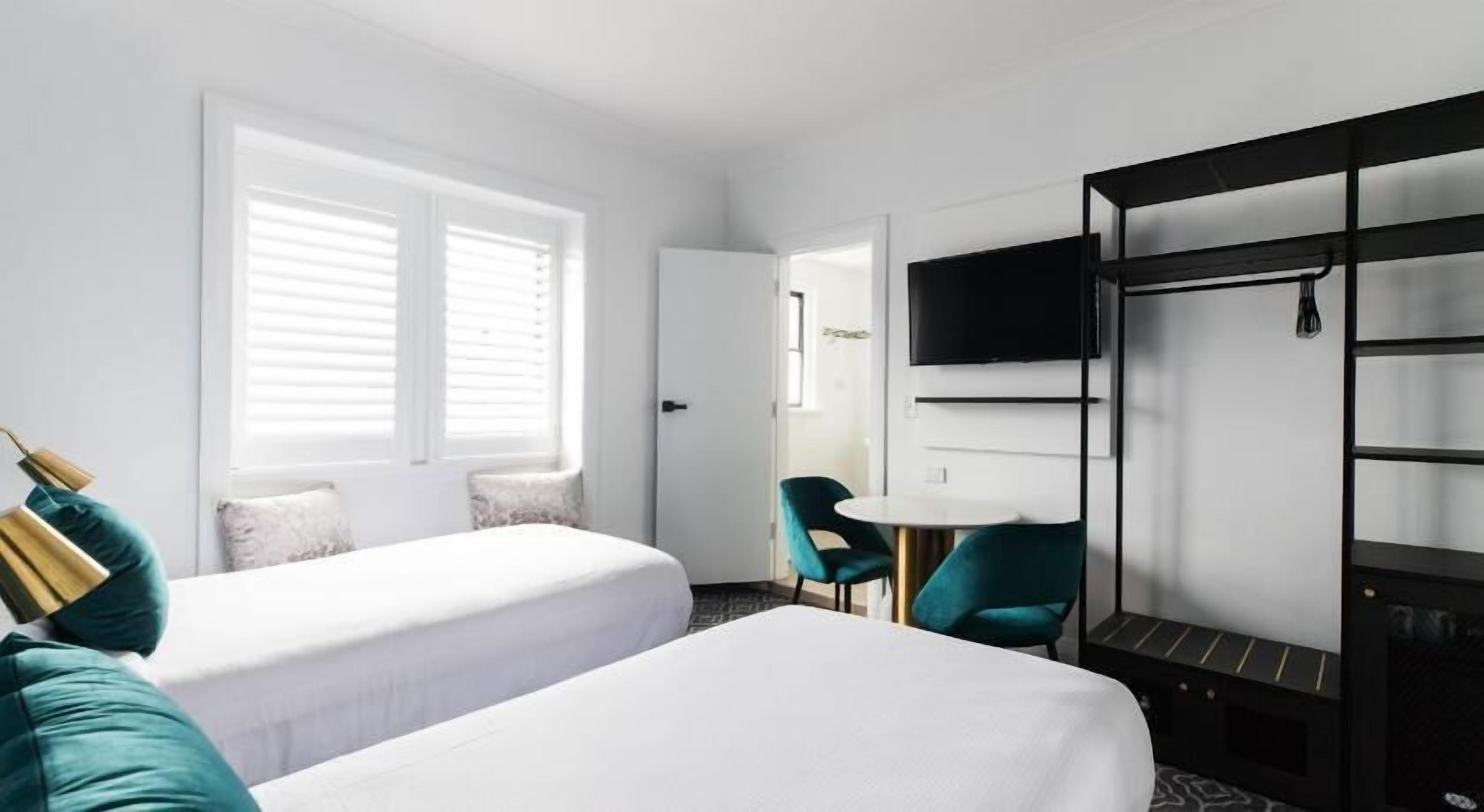 Premium bedding, desk, laptop workspace, blackout drapes