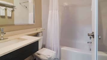 A bathroom with a sink, toilet, and bathtub.