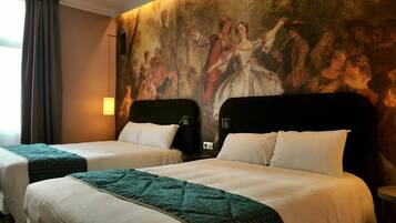 A hotel room with two beds, a large mural on the wall, and a window with curtains.