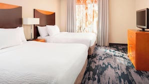 A hotel room with two beds, a TV, a lamp, and a large window with curtains. - Fairfield Inn & Suites by Marriott Selma Kingsburg (Kingsburg)