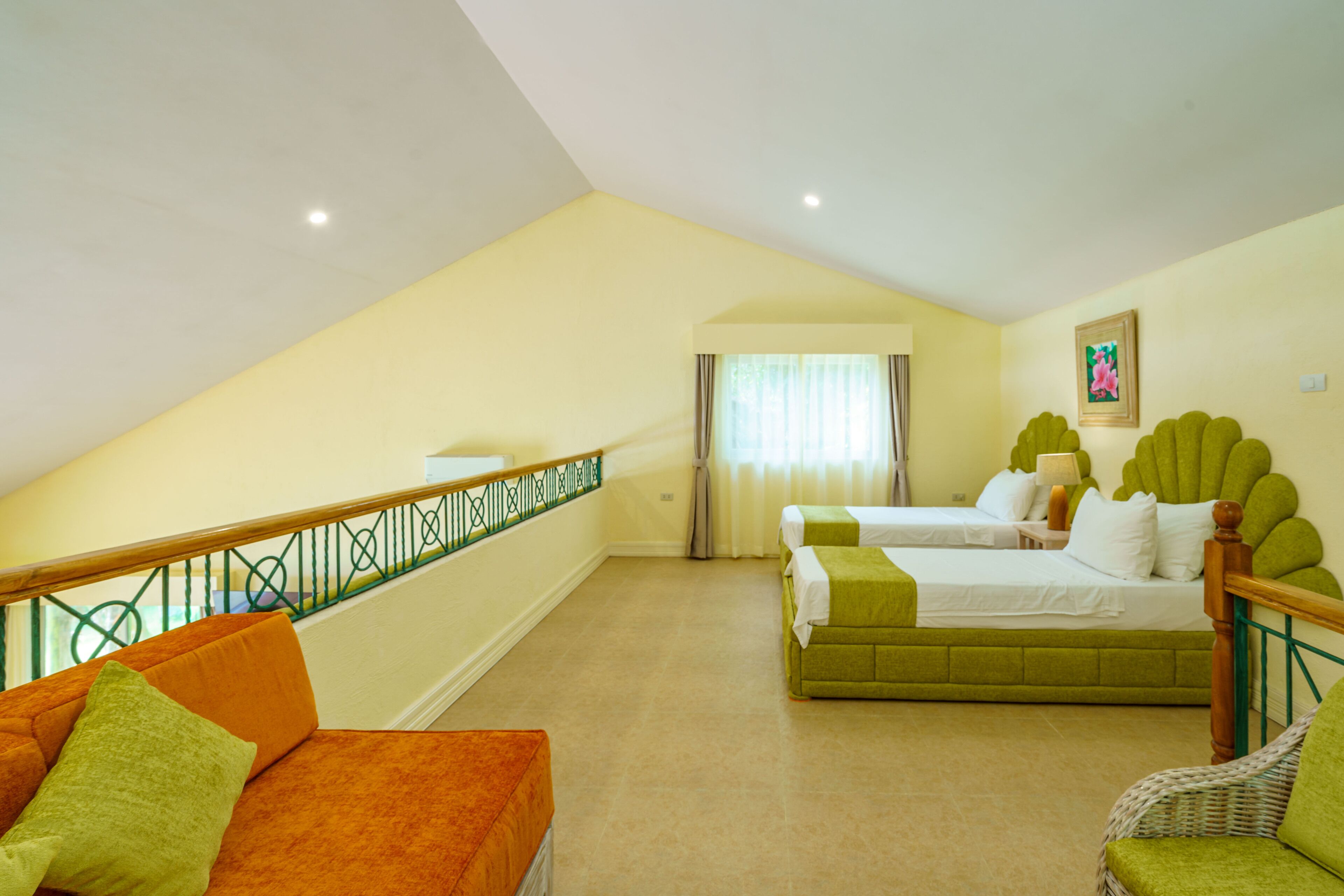 A room with two beds, a sofa, and a chair.