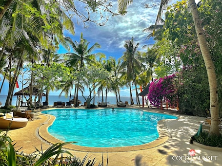 4 outdoor pools, pool umbrellas, sun loungers. Coco Grove Beach Resort