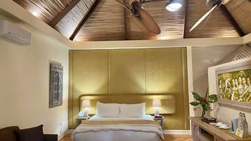 A hotel room with a large bed, a wooden ceiling, and a painting on the wall.