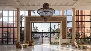 A spacious lobby with a large entrance, a patterned floor, and a hanging light fixture. - Aqualis Club Resort Marrakech (Marrakech)