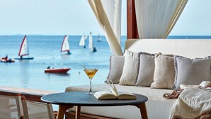 A seaside view from a balcony with a table, a drink, and an open book. - Leda Village Resort (South Pelion)