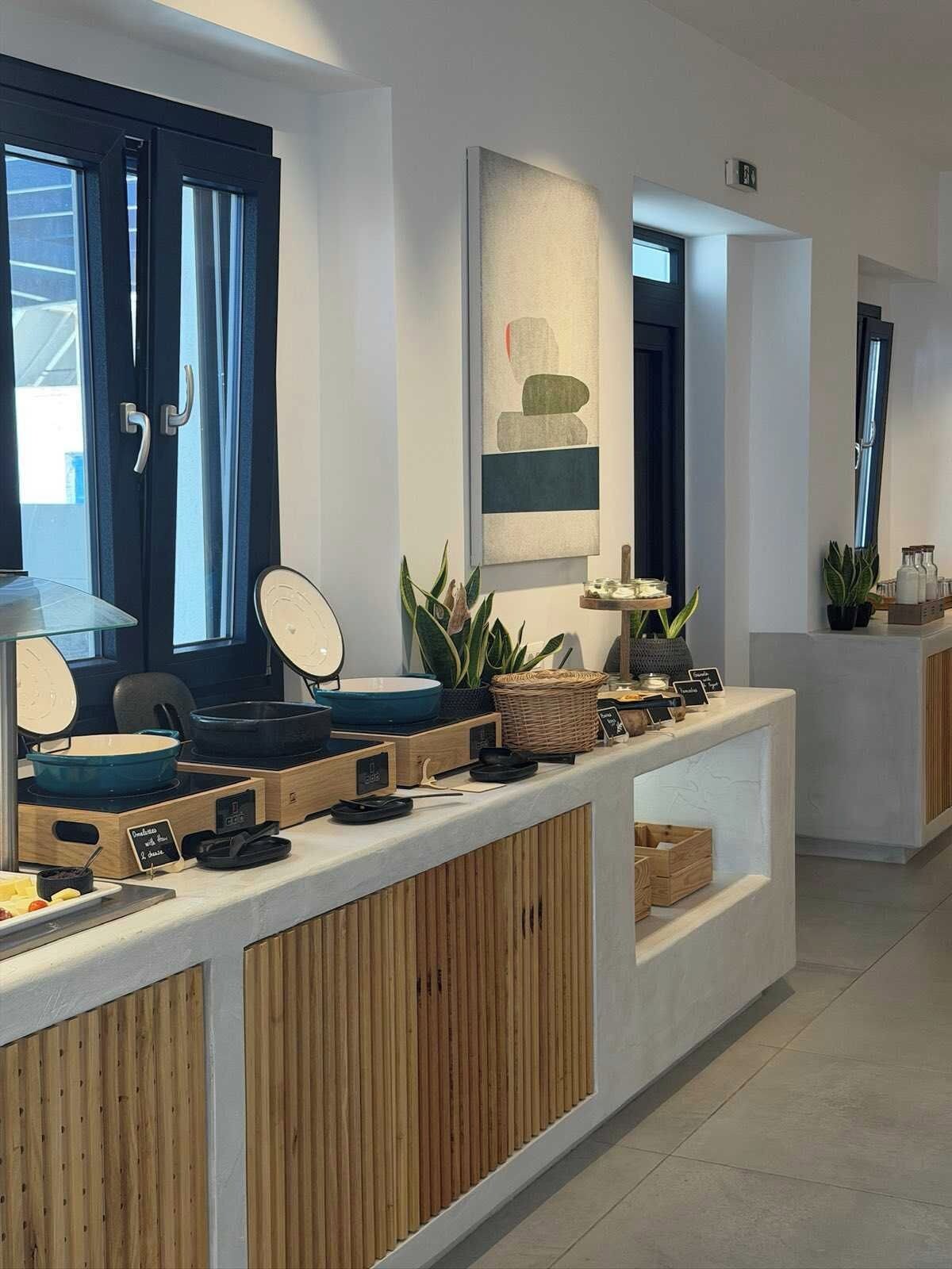 A modern kitchen with a wooden counter, a stove, and various kitchen utensils.