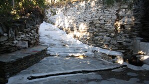 A stone pathway leading through a stone wall. - Amorani Studios (Andros)