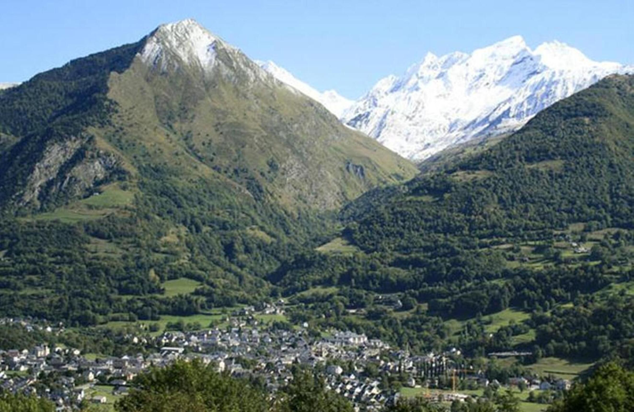 A mountainous landscape with a town nestled in a valley.